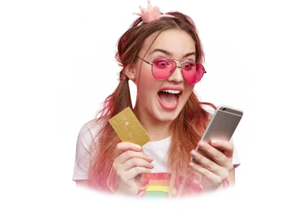 young woman looking at phone and holding credit card elated